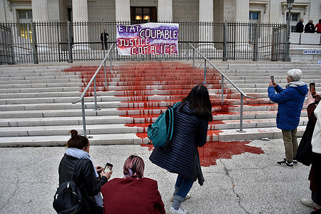 Demonstrators hang a banner on the gates of the courthouse and poured red dye representing the blood of the victims on the steps during the demonstration. Thousands of people demonstrated on the streets of Marseille on the occasion of International Women's Rights Day.
