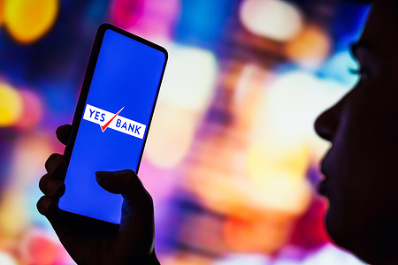In this photo illustration, the Yes Bank Limited logo seen displayed on a smartphone.