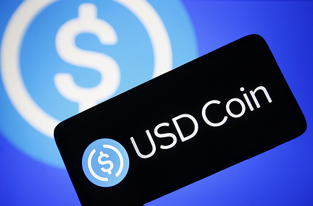 In this photo illustration, USD Coin (USDC) logo seen on a smartphone screen.
