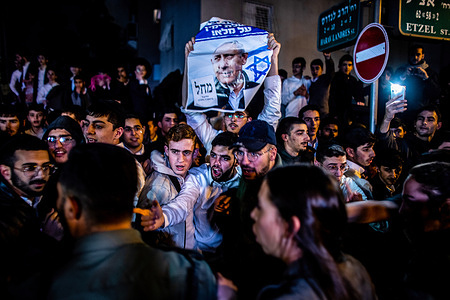 Ultra Orthodox Jewish youth holds a placard showing the portrait of Israeli Prime Minster Benjamin Netanyahu during an anti Judicial reform protest. Anti-government protesters rallied in Bnei Brak, near the home of Ultra-Orthodox party United Torah Judaism leader and Member of Knesset, Moshe Gafni, as part of the ongoing demonstrations against the right-religious coalition plans to radically overhaul the judicial system.