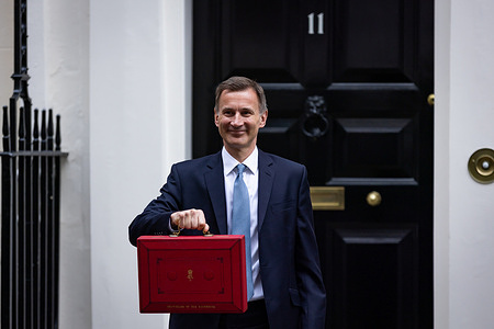 Chancellor of the Exchequer, Jeremy Hunt displays the red budget briefcase to the media in Downing Street, London. Highlights of the 2023 budget are an increase in the tax-free allowance for pensions which the Chancellor hopes will stem the number of people taking retirement, a package of help for swimming pools affected by the increase in energy bills and changes to childcare support for parents on universal credit.
