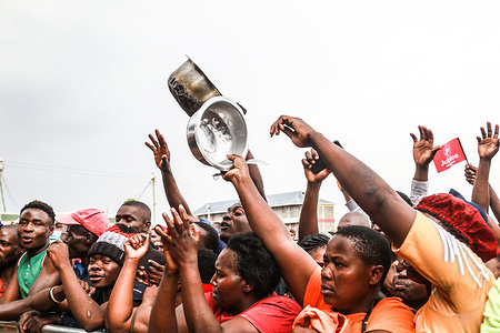 Supporters of Raila Odinga, former Kenyan presidential candidate react while raising cooking pots during his anti-government rally at Mazembe Grounds in Nakuru. Raila Odinga, who lost in the 2022 election, has been leading nationwide campaigns criticizing the government against high cost of living, which has left many Kenyans struggling to make ends meet.
