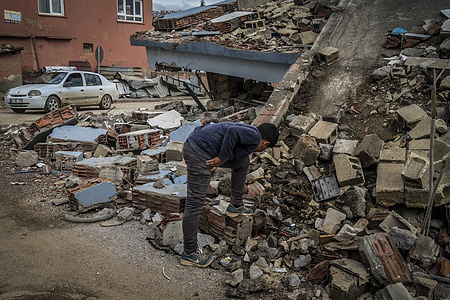 A young boy picking through earthquake wreckage. The İslahiye district of Gaziantep was one of the hardest hit by the February 6th earthquake with struck southern and central Turkey and northern and western Syria. The epicenter of the quake, which measured 7.8 on the richter scale was just 37 kilometers west-north-west of Gaziantep. As of 13 March 2023, more than 55,700 deaths have been confirmed: more than 48,400 in Turkey, and more than 7,200 in Syria.