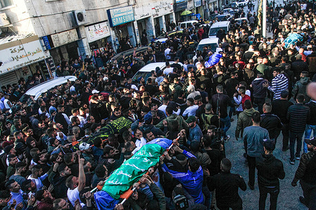 (EDITOR'S NOTE: Image depicts death)Mourners and gunmen carry the bodies of the four Palestinians who were shot dead by Israeli special forces in the city of Jenin in the occupied West Bank. An Israeli special force infiltrated the middle of the market in the city of Jenin and shot dead 4 Palestinians.