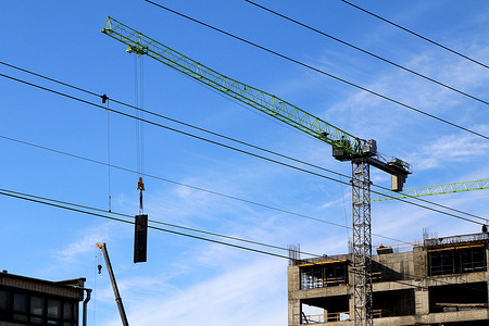 A construction crane works at a construction site in St. Petersburg, where a residential building is being built.