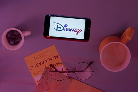 In this photo illustration, the Disney logo is seen displayed on a mobile phone screen.