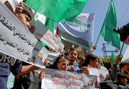 Palestinian children hold placards expressing their opinion during a stand in solidarity with Jerusalem and the West Bank in Khan Yunis, in the southern Gaza Strip.