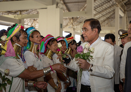Thai Prime Minister Prayut Chan-o-cha (R) receives flowers from women ethnic hill tribe at the Chiang Mai International Convention and Exhibition Center during the inspect government administration in Chiang Mai.