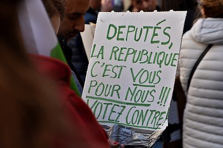 A protester holds a placard during the demonstration. At the call of several teachers' union organizations, teachers and parents of students from the schools of Castellane Saint-André (16th) and François-Moisson (2nd) demonstrate in front of the departmental directorate of education services (DSDEN) against the probable closure of classes at the start of the next school year.