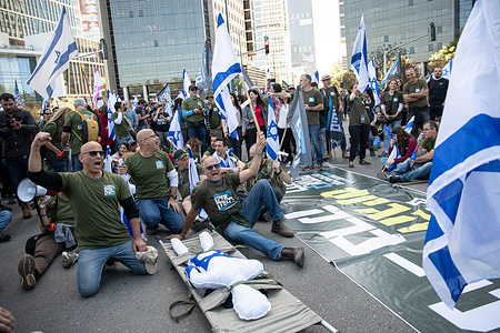 Israeli reserve soldiers against the judicial overhaul chant slogans in front of a stretcher with a figure and an Israeli flag during the demonstration. The soldiers opened a “recruiting centre” to IDF military service in a protestation act against the judicial overhaul in the Ultra-Orthodox city of Bnei Brak.