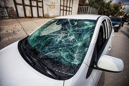 A view of an Israeli car that was damaged by Palestinian youths with stones after they claimed that there were Jewish settlers inside it, in the middle of the market in the city of Nablus in the occupied West Bank.