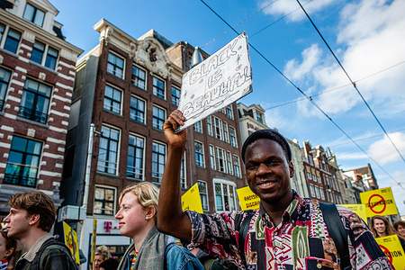 A black man is seen holding a placard in support of black people during the demonstration. Activists and anti-racists gathered at the Dam square in Amsterdam to ask for diversity and solidarity, and to protest against all forms of racism and discrimination to mark the Elimination of Racial Discrimination day. Also, against the racism and discrimination that have become increasingly visible in Dutch official institutions.