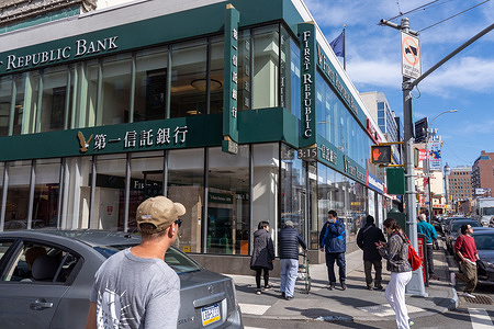 People walk past a First Republic Bank branch in Chinatown Manhattan in New York City. First Republic shares tank on Friday almost 33% despite $30 billion support.
