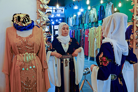 Kurdish fashion designer Yasemin Suleymanoglu wears a Kurdish national costume she designed and sewed herself.