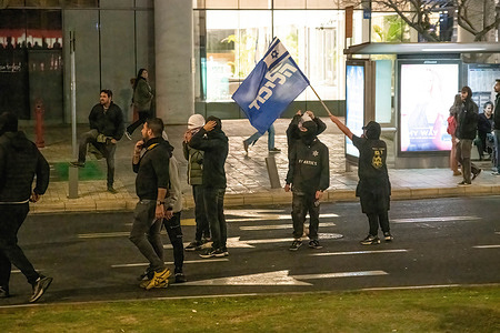Masked Right-wing pro-reform supporter waves a Likud party flag during the demonstration. As the controversial legal overhaul demonstrations went on, confrontations occurred between anti-reform protestors and pro-reform right-wing activists.