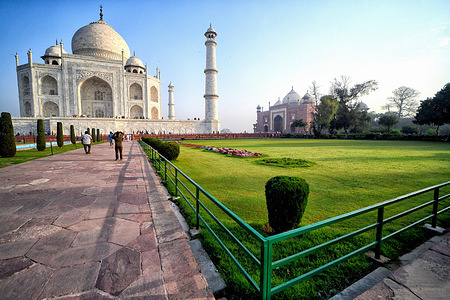 Tourists visit the Taj Mahal in Agra. The Taj Mahal is a mausoleum located in the right bank of the river Yamuna - Agra, India, built by Mughal Emperor Shah Jahan in memory of his favorite wife, Mumtaz. The Taj Mahal is considered the finest example of Mughal architecture, a style that combines elements from Persian, Oman, Indian, and Islamic architectural styles. The Taj Mahal is in the list of modern Seven Wonders of the World and It has also been a protected UNESCO World Heritage Site since 1983.