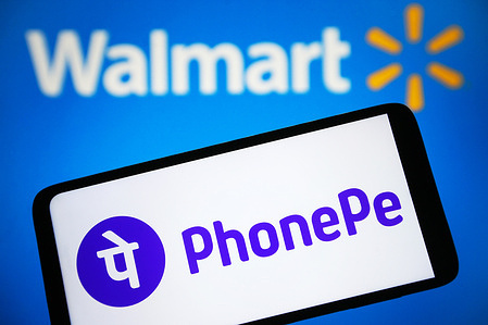 In this photo illustration, a PhonePe logo is seen on a smartphone with a Walmart Inc. logo on the background.