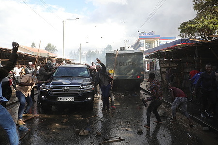 Supporters surround opposition leader, Raila Odinga's vehicle on the streets of Mathare North during a demonstration against the cost of living and President William Ruto's administration.