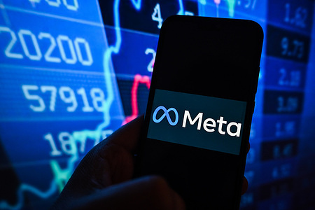 In this photo illustration, a Meta logo is displayed on a smartphone with stock market percentages in the background.