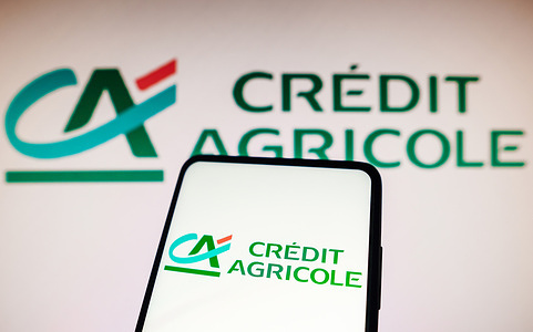 In this photo illustration, the Crédit Agricole logo is seen displayed on a smartphone.