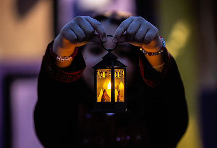 A Palestinian girl holds a traditional lantern in Gaza City, where lanterns are used as decorations to celebrate the beginning of the holy month of Ramadan.