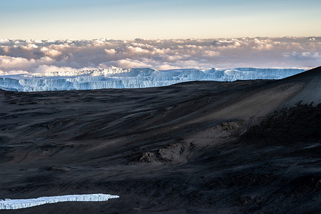 A small portion of the glacier left on top of Kilimanjaro. The melting glacier on top of Mount Kilimanjaro. Several studies have shown the glacier has shrunk by 80% since the early 20th century and U.N. experts say the ice cap on Africa's biggest peak, is predicted to melt by 2050 due to climate change.