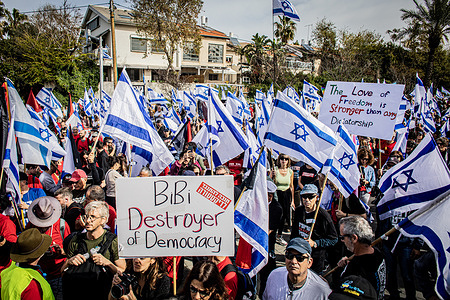 Protestors hold placards and wave the Israeli flags during an anti Judicial reform protest. Protests against the government's judicial overhaul took place in Jerusalem and Tel Aviv with several targeting government ministers as the coalition pushed ahead with its controversial plans.