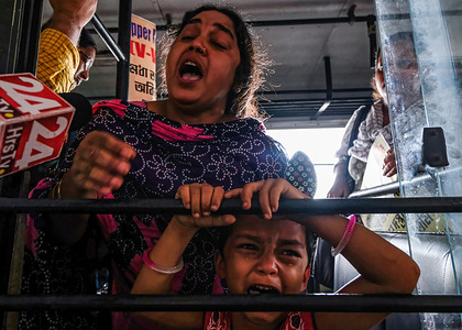 Police officers arrest a mother and child during a demonstration against the ruling government for not recruiting eligible candidates for the West Bengal Upper Primary TET examination.