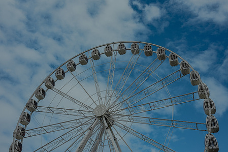 A close-up shot of the Ferris wheel's spokes and structure, emphasizing the intricate design and engineering required to create such a captivating ride.