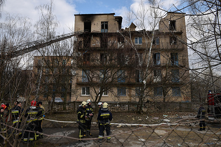 Rescuers work at the site of a building heavily damaged by Russian drone strikes during Russia's attack in the city of Rzhyshchiv, Kyiv region.
