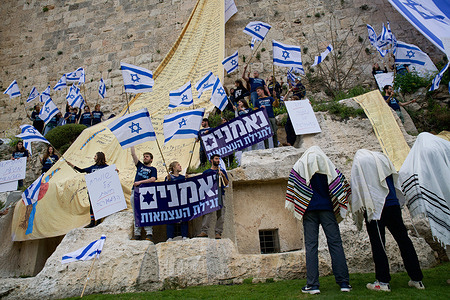 A group of demonstrators in Jerusalem's Old City draped the national flag of Israel and copies of the Israeli Declaration of Independence on the walls as an act of protest against the controversial judicial overhaul being pursued by the nationalist coalition government led by Prime Minister Benjamin Netanyahu.