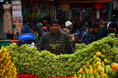 A Kashmiri street vendor sells grapes at a market during the first day of the Muslim holy month of Ramadan in Srinagar.