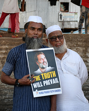 Congress supporters hold a placard with a picture of the Indian National Congress President Rahul Gandhi during a silent protest in Mumbai. Congress supporters protested against the two year jail conviction announced for the Indian National Congress President Rahul Gandhi in a Defamation case by Surat (city in Gujarat) court in the year 2019.