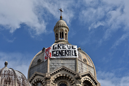 A banner calling for a general strike is seen hanging on the large dome of the Sainte-Marie-Majeure (La Major) cathedral in Marseille. As part of the 9th day of mobilization against the pension reform organized by several unions, demonstrators hanged a banner calling for a general strike on the main dome of the Sainte-Marie-Majeure (La Major) cathedral in Marseille. This pension reform wanted by the French government raises the retirement age from 62 to 64 years.