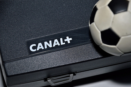 In this photo illustration, the CANAL+ logo and a mini soccer ball are seen on a decoder box of the channel. The broadcasts of Ligue 1 soccer and Top 14 rugby matches were disrupted on April 15, 2023 by a social movement by technicians from a television channel provider who were demanding an improvement in their salary conditions.
