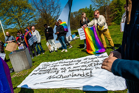 Protesters are seen placing banners in support of LGBTQIA+ asylum seekers on the ground during the demonstration. LGBTQIA+ people, who had to become refugees due to militant homophobia in their home countries, face violence and humiliation every day and commit suicide due to a lack of protection and medical care in the refugee centers in the country. Because of this, the 'Rainbow Rights Activists' organization held a safety rally to demand protection and security for LGBTQIA+ asylum seekers. The protest took place at the International Gay Monument placed in The Hague.