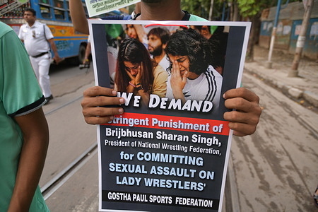 Young athlete of Kolkata holds a placard as he takes part in a solidarity march in support of the wrestlers' against WFI Chief Brij Bhushan Sharan Singh. The protesting wrestlers accused the WFI president of sexually harassing several women wrestlers, including a minor.