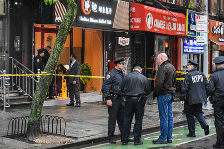 A man and police officers seen during the investigation. Police investigate the shooting incident. Shooting in Manhattan, New York, United States on April 29, 2023. At 17:43 Saturday evening one person was shot in the hip and shoulder near the area of 9th Avenue and West 46th Street. According to the New York City Police Department, the person shot is in stable condition. No suspects are captured at this time.