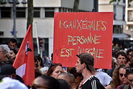 A protester holds a placard expressing his opinion during the demonstration. Protesters were demonstrating against planned changes to immigration laws and the recent eviction operation (known as Wuambushi) on the French Indian Ocean island of Mayotte. Critics say the new law is racist and will criminalise immigrants.