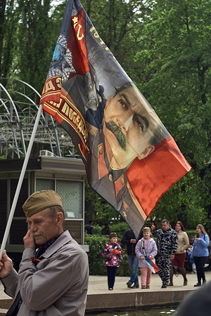 A participant holds a portrait of Joseph Stalin on a flag in Koltsovsky Square on the Victory Day of the Soviet Union over Nazi Germany in Voronezh. Two years after Russia invaded Ukraine more and more nationalist symbols are mixed with Soviet ones. People celebrate Victory Day by walking around the city, singing patriotic songs and paying respect to the dead.