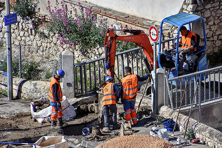 A construction machine and workers are seen at a drinking water network renewal site. The Société Eau de Marseille Métropole, acting on behalf of the Aix Marseille Provence Métropole, is replacing 827 meters of drinking water pipes in the 16th arrondissement of Marseille. The renewal of this drinking water network, which began on January 2, 2023, should end on July 28, 2023.