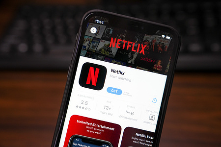 In this photo illustration, the Netflix app is displayed in the App Store on an iPhone.