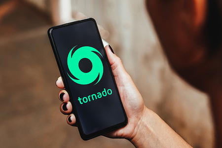 In this photo illustration, the Tornado Cash logo is displayed on a smartphone screen.