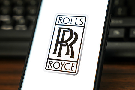 In this photo illustration, the logo of Rolls-Royce Holdings is displayed on the screen of a smartphone.