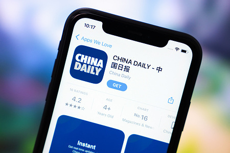 In this photo illustration, the app logo of China Daily is displayed in the App Store of an Apple phone.