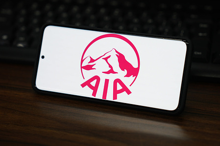 In this photo illustration, an AIA logo is displayed on the screen of a smartphone.