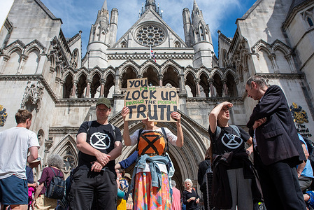 A protester seen holding a placard during the demonstration. Just Stop Oil and Extinction Rebellion protesters have gathered outside the Royal Court of Justice to show their support to Marcus Decker and Morgan Trowland during their appeal. Trowland was jailed for three years and Decker for two years and seven months following a trial for scaling the Dartford Bridge. Meanwhile, Marcus Decker is facing a possible deportation as well as a foreign citizen.