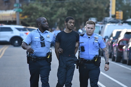 A suspect is taken into custody following a barricaded situation, Thursday evening. Suspects were taken into custody following a barricaded situation in Philadelphia, Pennsylvania, United States on July 27, 2023. Three suspects were originally taken into custody following a short standoff, after a short while, the suspects were taken into custody. One person was released from custody and the other two individuals remained in custody. Originally, one person, a 21-year-old black male that was inside the residence on Buist Avenue was wanted for a shooting, was armed with a gun and refused to vacate the house.