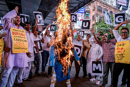 Members of the Indian National Congress party burn an effigy of India’s Prime Minister Narendra Modi as they hold placards and chant slogans during a protest march over sexual violence against women in the northeastern state of Manipur in Kolkata. At least 130 people have been killed, and more than 60,000 were displaced as ethnic violence continues since the clashes broke out between two ethnic groups Kukis and Meiteis in May in the state of Manipur. The Supreme Court of India on 20 July took suo motu cognizance after a viral video of naked women being paraded and sexually assaulted in the violence-hit northeastern state of Manipur, and termed it 'deeply disturbing' and the 'grossest violation of constitutional and human rights'.