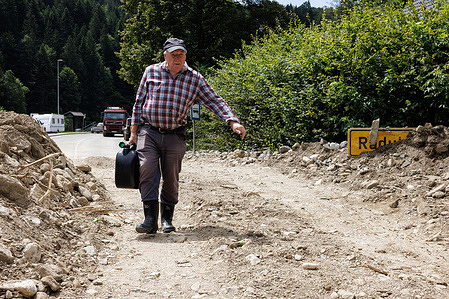 A man carries fuel for heavy machinery cleaning the flood-debris in Raduha after major flooding hit two thirds of the country days ago. Clean-up and rescue efforts are ongoing after major flooding in Slovenia. Some areas in Savinja river valley are still cut off from the world. The damage is enormous.